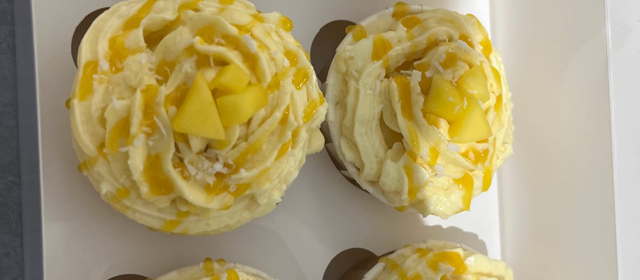Mango & coconut cupcakes topped with fresh mango