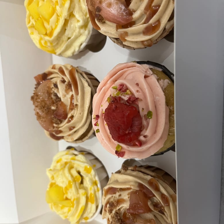 Box of raspberry & pistachio cupcakes