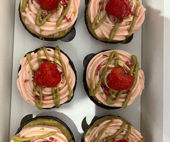 Raspberry & pistachio cupcake with a fresh raspberry on top